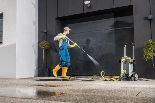 men-pressure-washing-his-garage-gate_1426-8355